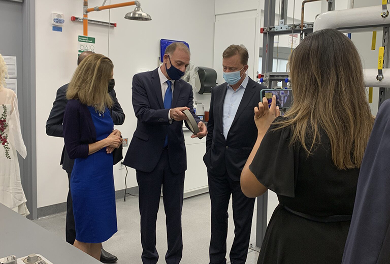 photo of Governor Ned Lamont and Lt. Governor Susan Bysiewicz talk with Associate Dean and Executive Director of the UConn Tech Park Pamir Alpay in the Pratt and Whitney Additive Manufacturing Center. (UConn Photo/Eli Freund)