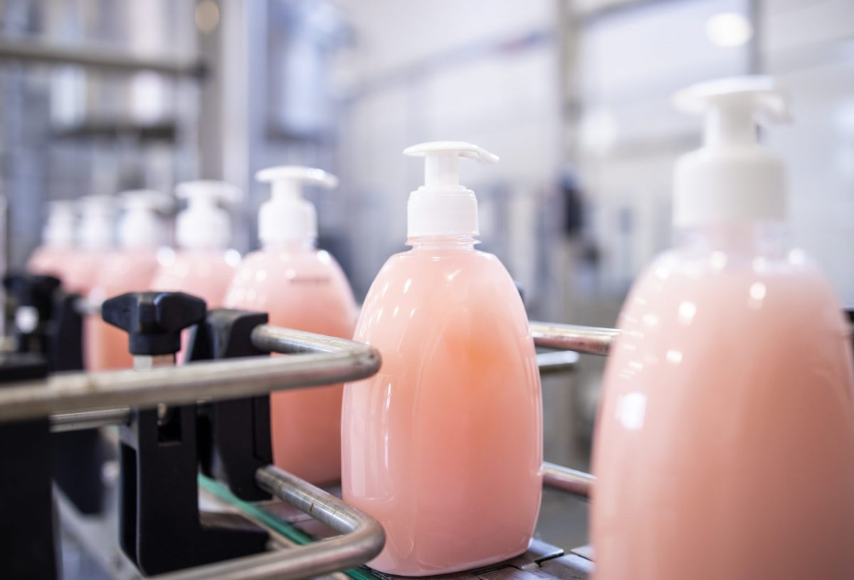 Bottled liquid soap being produced in factory.