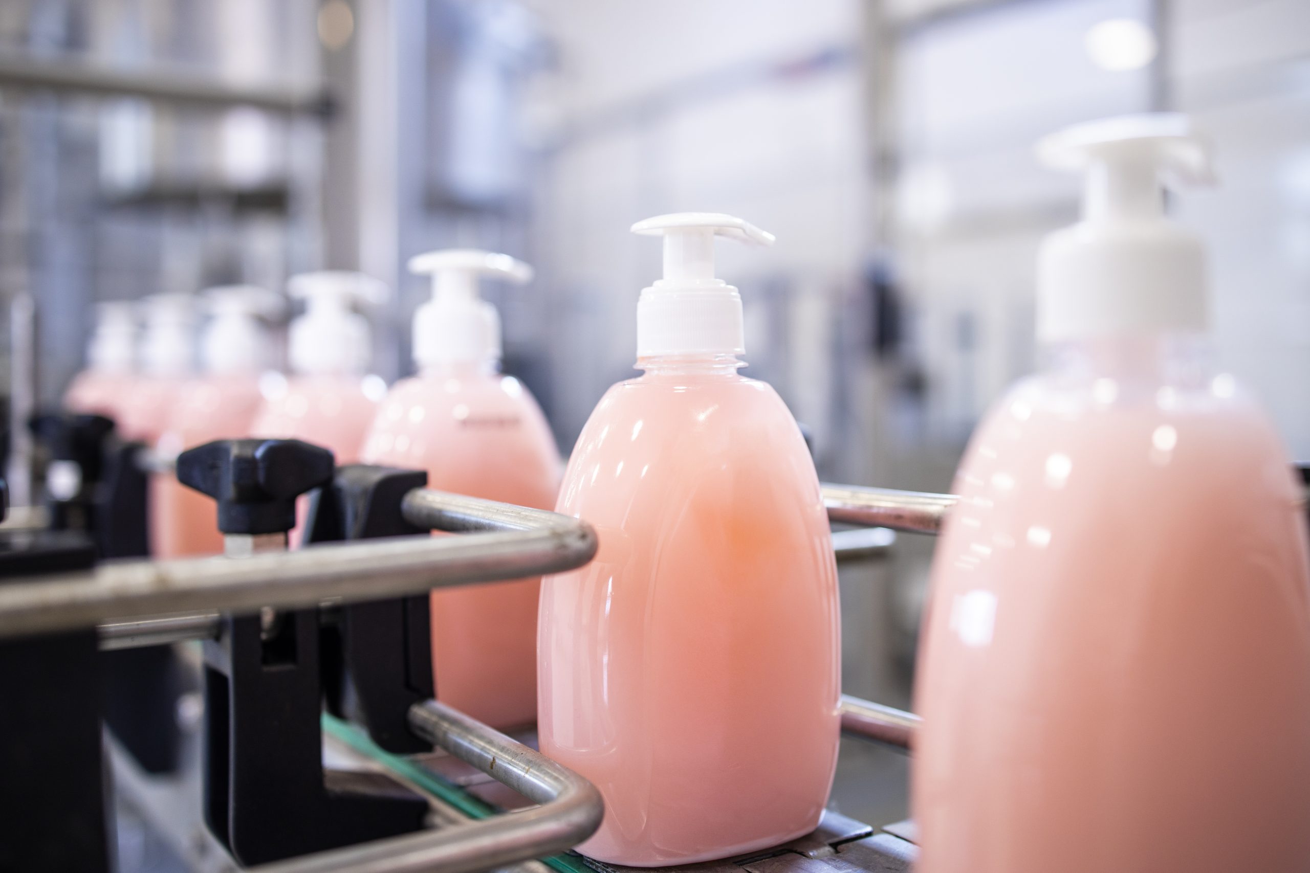 Bottled liquid soap being produced in factory.