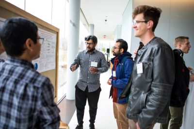 Poster session with four students.