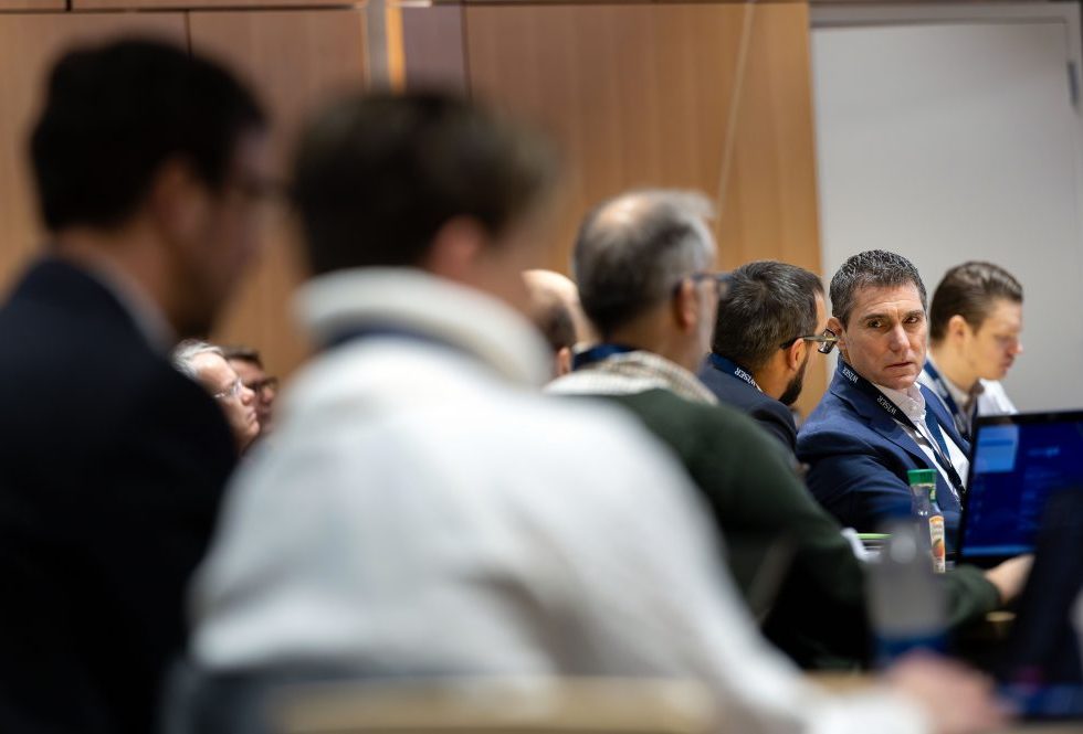 A group of men attending a lecture event