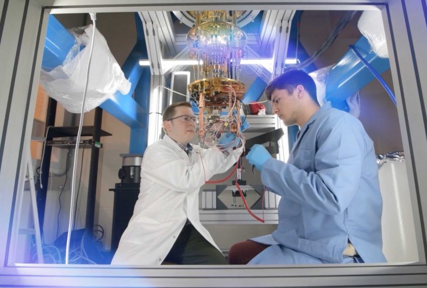 two researchers work on a quantum computer